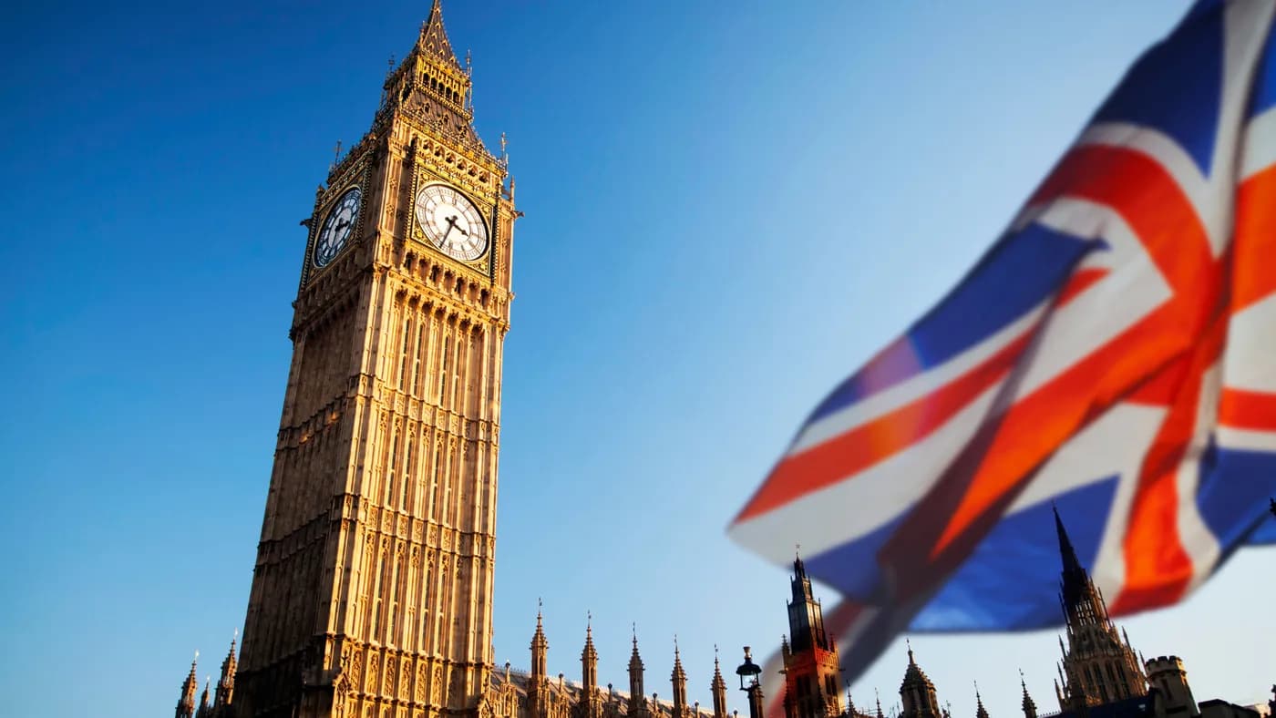 Big Ben and the Houses of Parliament with a Union Jack flag in the foreground